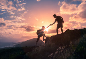 Image of one person helping another to illustrate counselling